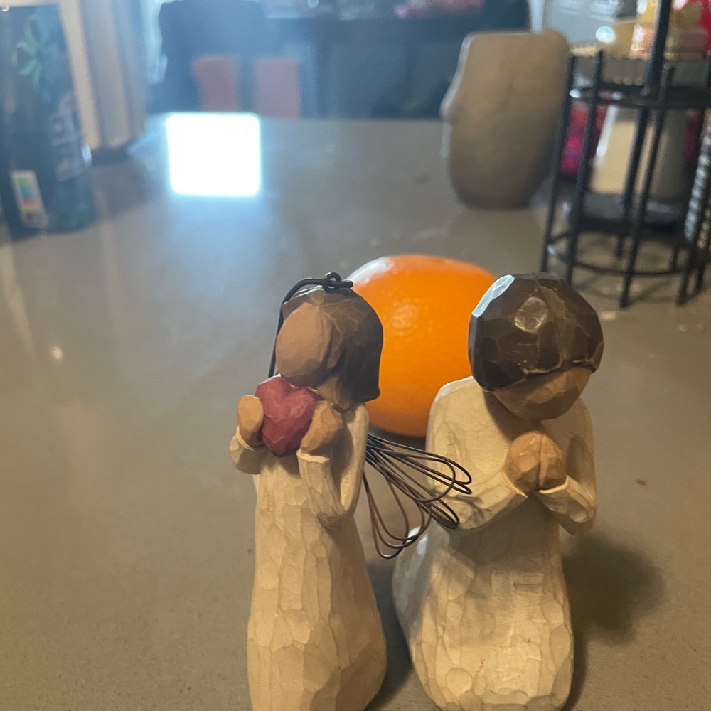 Carved Figurines Holding Heart